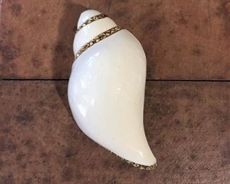 St. John enamel shell brooch outlined in rhinestones. Size 1 1/8" wide by 2" high. Signed with the circular SJ logo mark on back. $68