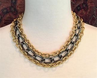 Alexis Bittar chain link necklace measuring 18" long .   Contrasting triple strands, two goldtone, one gunmetal gray.  Signed Alexis Bittar $228 