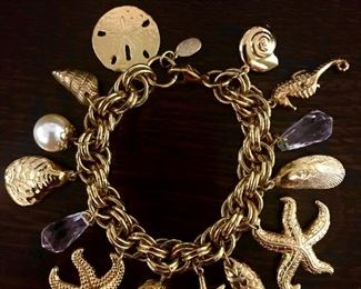 Kirk's Folly signed seashore themed charm bracelet with seahorse, shells, sand dollar, starfish, and faux pearls.  7.25" long.  $88