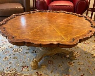 Beautiful coffee table with pedestal base and Chippendale rim