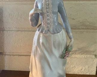 Porcelain figurine of woman holding flowers by NADL