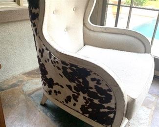 Wing back chair with a faux cowhide accent 