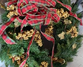 Christmas wreath with gold berries and tartan plaid ribbon 