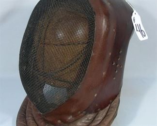 Vintage  leather fencing mask on stand