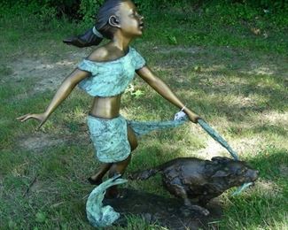 Adorable sculpture of young girl with playful dog