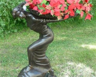 Bronze sculpture of woman holding tray