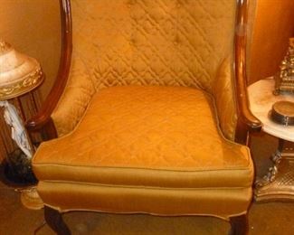 Gold upholstered chair..walls are dark gold, so it blends!!