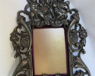 Frame W/ Cherubs/Putti & Sea Dragons. Marked on Back. Over all frame size 14" T x 10 1/4" W.  Interior dimensions 4 1/4" x 6"