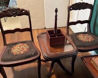 Pair of carved-rose-back chairs with needlepoint seats.