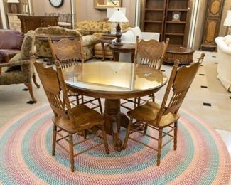 Oak pedestal dining table and chairs.  The braided rug is one of my favorites!