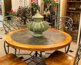 HEAVY wrought iron/wood stone top table and four chairs.
