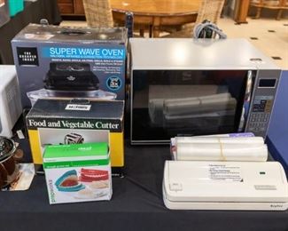 NEW Super Wave Oven!  The Microwave looks as though it has never been used.  Food Saver on the right.