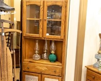 Corner cabinet, antique sled, and several pairs of ice skates!  Don't miss the vintage lamp on top!