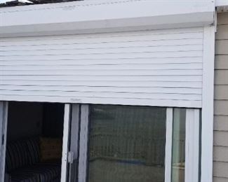 Electric storm shutter installed and maintained by Bill'd Canvas Shop; works perfectly! Approximately 7 feet wide