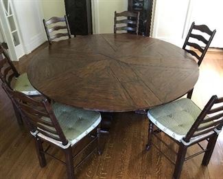 Eight French Heritage pine ladder back chairs, rush seats with custom cushions. From ABC Carpet NYC.