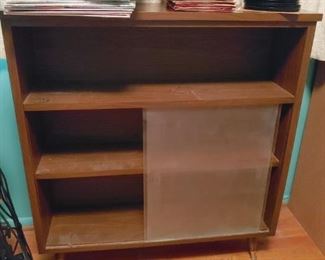 mid century peg leg book shelf with sliding doors