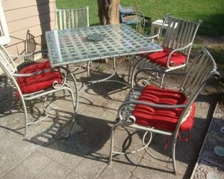 Heavy wrought iron patio table with 4 chairs