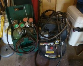 Cutting torch with bottles and Central Pneumatic pancake air compressor