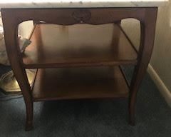 One of pair of marble top tables