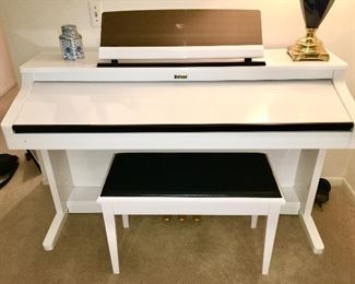 Roland digital piano,  Model Number is 
KR-577 Digital Intelligent piano.  The tag lists the model as ”KR577PW.  The serial number is Z091229. 