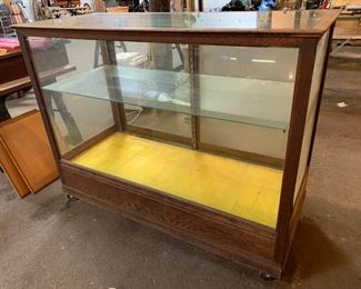 Wood and glass display shelf on wheels