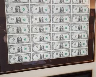 uncut, uncirculated framed one dollar bills