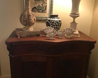 Victorian bow front two door chest.
Hand carved bone vase from China.
Chinese silk painting.