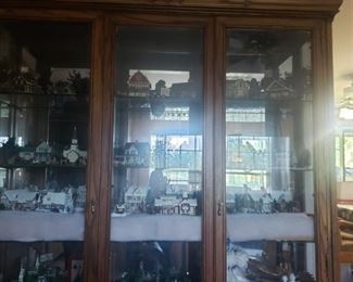 This whole cabinet is full of lighted Christmas houses