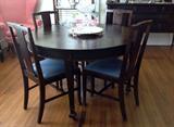 1940's round dining table with 5 leaves in case and pads.