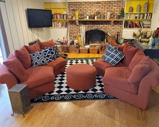 Four piece round burnt orange sectional with ottoman. Black and white checkered floor rug