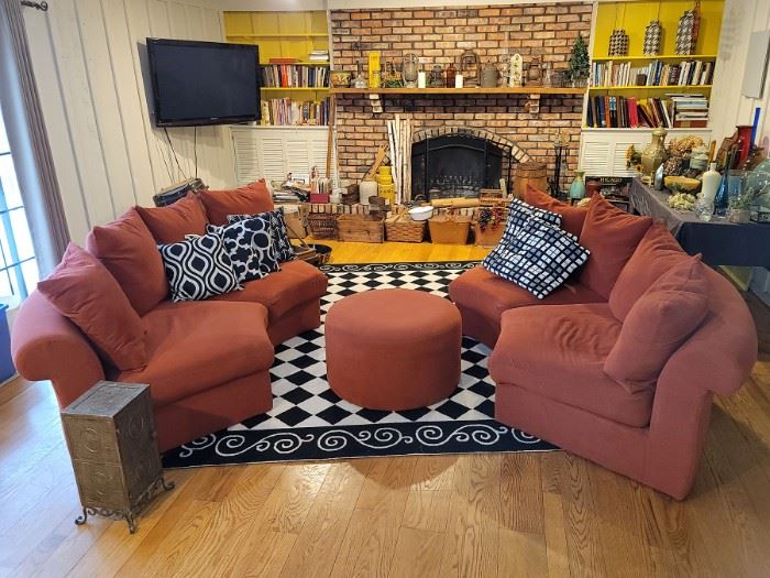 Four piece round burnt orange sectional with ottoman. Black and white checkered floor rug