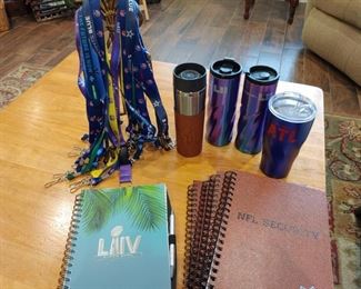 Assorted NFL and Superbowl notebooks, lanyards, and beverage cups