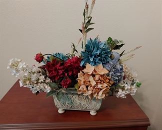 Floral arrangement in clay container