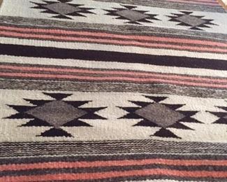 Navajo rug.  Vintage.  Rare pinkish color bands with light green thin bands.  Mounted on board for wall hanging. 34" wide by 57" long with 2" wide mount board.  Excellent condition.  $1400.00
