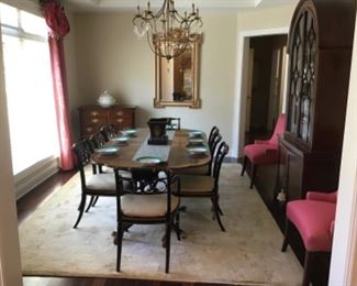 This gorgeous dining room is furnished with a mahogany double pedestal table by Baker $1,800, eight dining chairs by Baker $2,200 and the curved top china cabinet is also by Baker $1,500