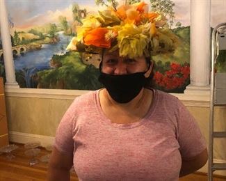 Sofia having fun with the many hats for sale.