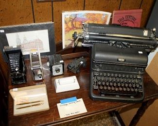 Antique Royal typewriter with glass keys, vintage cameras