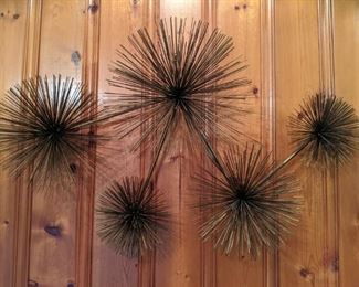 Socially distancing, wall crawling brutalist brass sea urchins.                                                                                                            I wonder if Orkin or Arrow can treat knotty pine paneling for these things?