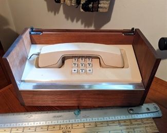 Vintage Western Electric Stowaway telephone in teak and chrome box; serial number 719236; approximate measurements:
Length: 11" Width: 5-1/2" Height: 6".