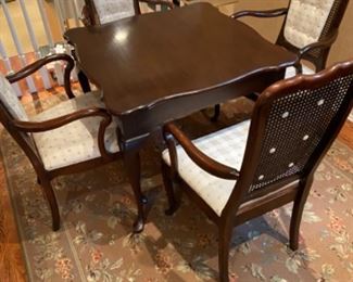 Harden Chocolate Brown Antique Dining Table and 4 antique Dining Cane Chairs. Floral Area Rug.