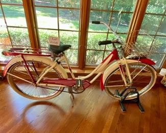 Lot 2108. $450.00. Probably a steal. Woman's Vintage Monark Silver King Roadster Bicycle with Basket, Rear View Mirror, in Red and Cream. An iconic aluminum vintage bicycle from a local Chicago Manufacturer from the early 1930s through the 1950's. In remarkable condition - Most of these bicycles were destroyed during the metal shortage of World War II, so they are quite rare. Look up https://www.madeinchicagomuseum.com/single-post/monark-silver-king/t 32" H to Seat. Needs new tires.