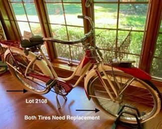 Lot 2108. $450.00. Probably a steal. Woman's Vintage Monark Silver King Roadster Bicycle with Basket, Rear View Mirror, in Red and Cream. An iconic aluminum vintage bicycle from a local Chicago Manufacturer from the early 1930s through the 1950's. In remarkable condition - Most of these bicycles were destroyed during the metal shortage of World War II, so they are quite rare. Look up https://www.madeinchicagomuseum.com/single-post/monark-silver-king/t 32" H to Seat. Needs new tires.