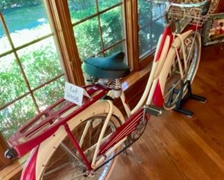 Lot 2108. $450.00. Probably a steal. Woman's Vintage Monark Silver King Roadster Bicycle with Basket, Rear View Mirror, in Red and Cream. An iconic aluminum vintage bicycle from a local Chicago Manufacturer from the early 1930s through the 1950's. In remarkable condition - Most of these bicycles were destroyed during the metal shortage of World War II, so they are quite rare. Look up https://www.madeinchicagomuseum.com/single-post/monark-silver-king/t 32" H to Seat. Needs new tires.