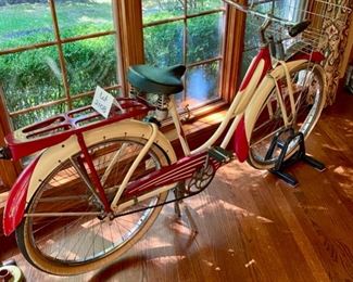 Lot 2108. $450.00. Probably a steal. Woman's Vintage Monark Silver King Roadster Bicycle with Basket, Rear View Mirror, in Red and Cream. An iconic aluminum vintage bicycle from a local Chicago Manufacturer from the early 1930s through the 1950's. In remarkable condition - Most of these bicycles were destroyed during the metal shortage of World War II, so they are quite rare. Look up https://www.madeinchicagomuseum.com/single-post/monark-silver-king/t 32" H to Seat. Needs new tires.