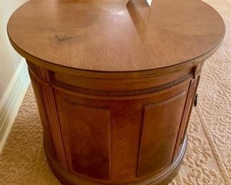 Lot 2125 $95.00 Thomasville Drum Table, with a delicately carved accent. The cabinet opens with double doors, for great storage within. There is a water stain on the top. 24.5" Diameter x 22" H. For half price this is a steal!