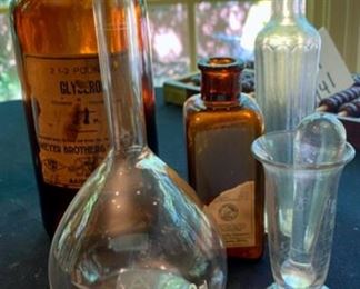 Lot 2139 $35.00 Grouping of glass bottles: Antique Amber glass pharmacy apothecary bottle - Myer Bros. St. Louis; Upjohn Co 1906 amber medical bottle; Mortar & Pestle clear antique glass; 500 ml beaker by Kimax; Tall, slender medicine bottle