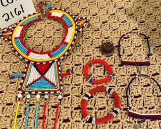 Lot 2161, $50.00. African beaded grouping (from Kenya): Large Beaded Necklace in multiple colors, 2 beaded necklaces, 2 beaded bracelets, and 1 beaded finger cap.