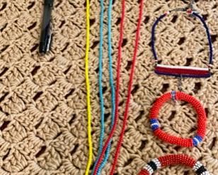 Lot 2161, $50.00. African beaded grouping (from Kenya): Large Beaded Necklace in multiple colors, 2 beaded necklaces, 2 beaded bracelets, and 1 beaded finger cap.