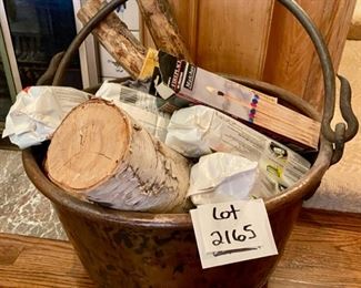 Lot 2165 $375.00 Large, antique hammered copper cauldron pot with forged iron handle, filled with logs and fireplace matches. 24"d x 12"h