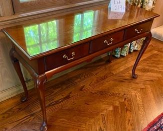 Lot 2146 $250.00 Hickory Chair Queen Anne Style Writing Desk 1. One bracket on the right needs to be repaired or replaced. 2. Some Wear on Desktop. 48" L x 17" D x 27.5" H Beautiful and graceful lines; a topnotch design.